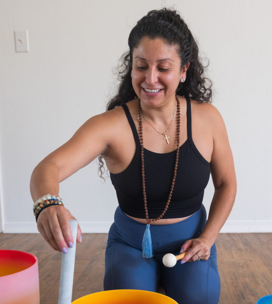 Samantha Spitzer using a mallet and a soothing sound bath for a class